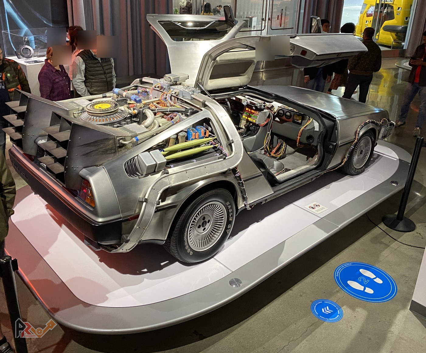 The same DeLorean seen from the rear three-quarter: flux capacitor, cables and film boxes, above the PRV V6